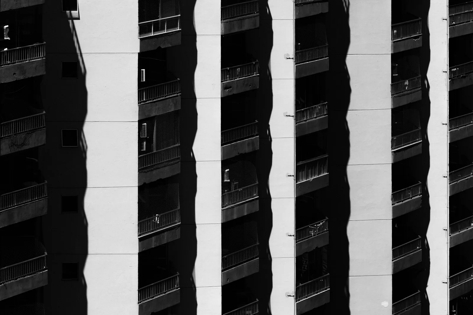 The geometric rhythm of balconies on a residential facade in Rio.